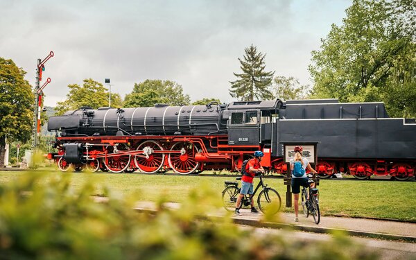 Altmühltal-Radweg – Radler an Eisenbahn in Treuchtlingen