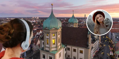 Frau shcaut mit Kopfhörern auf ein Bild das eine Vogelperspektive einer Stadt zeigt