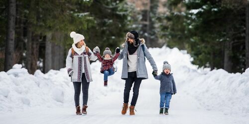 Junge Familie bei Spaziergang im Schnee